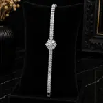 Silver zircon tennis bracelet with floral snowflake centerpiece on black display