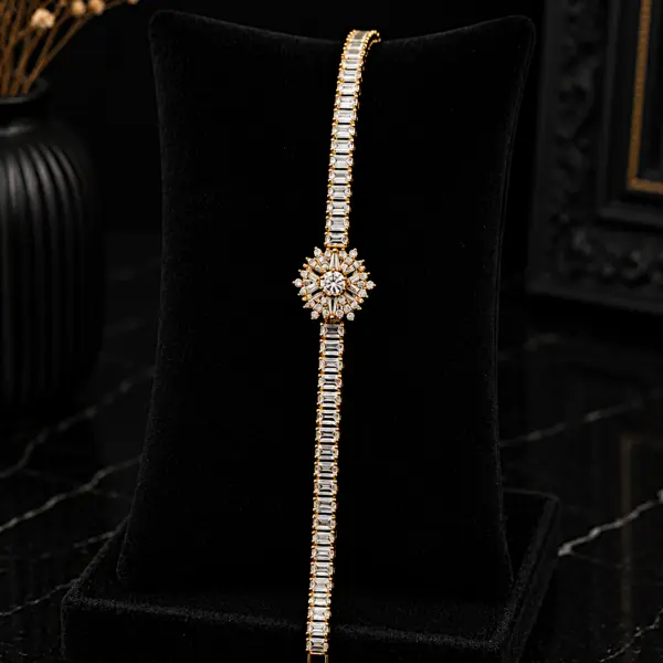 Gold plated zircon tennis bracelet with starburst flower center on black velvet display