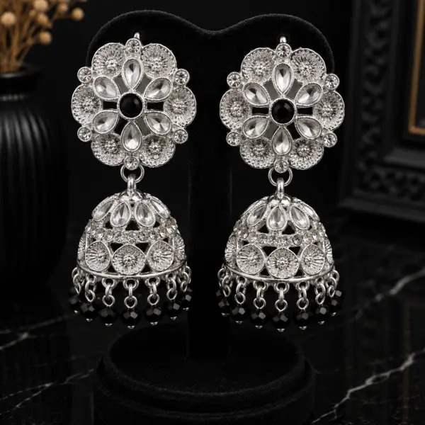 Silver floral Kundan jhumka earrings with black center stones and black crystal bead drops