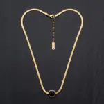 Classic gold twisted rope chain necklace suspended over elegant silk background