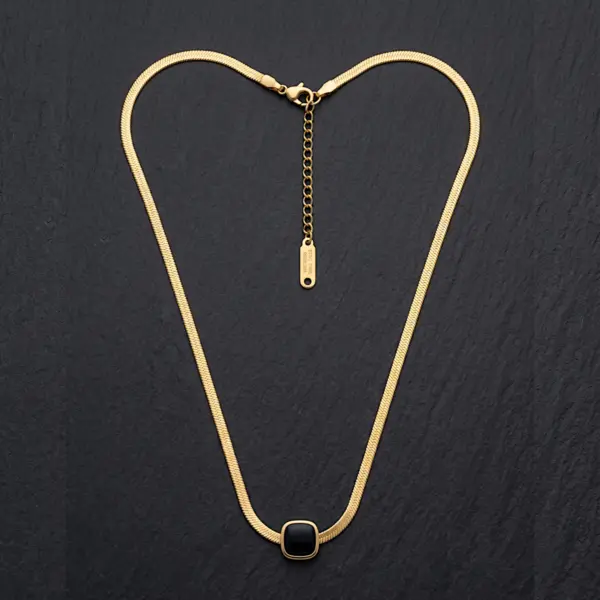 Classic gold twisted rope chain necklace suspended over elegant silk background