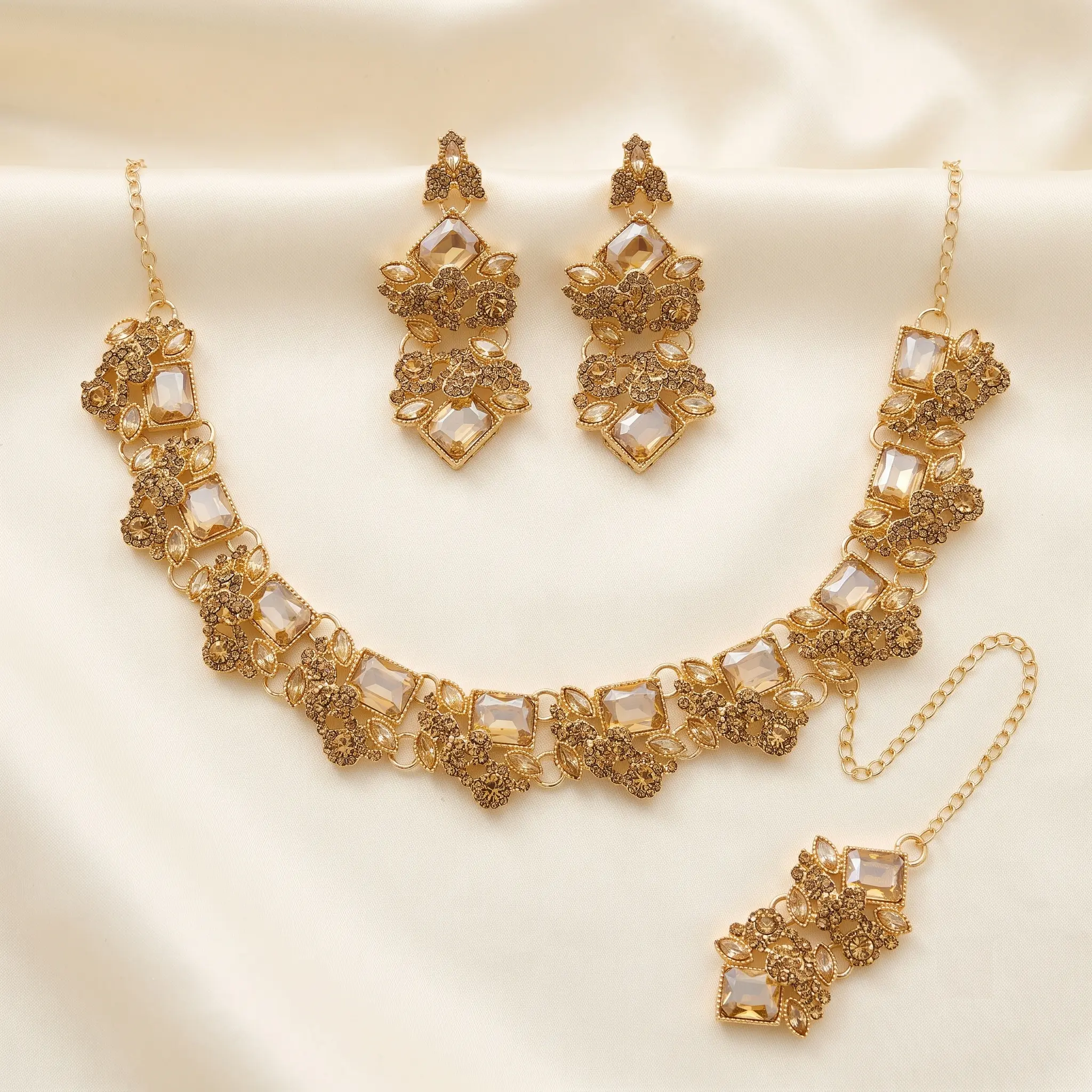 Gold champagne crystal choker necklace set with statement earrings and maang tikka