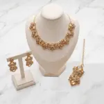 Gold champagne gem choker necklace set with matching drop earrings and maang tikka