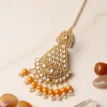 Traditional gold plated Kundan Jhumar passa with orange pearl drops and pearl chain for Mehndi hairstyles